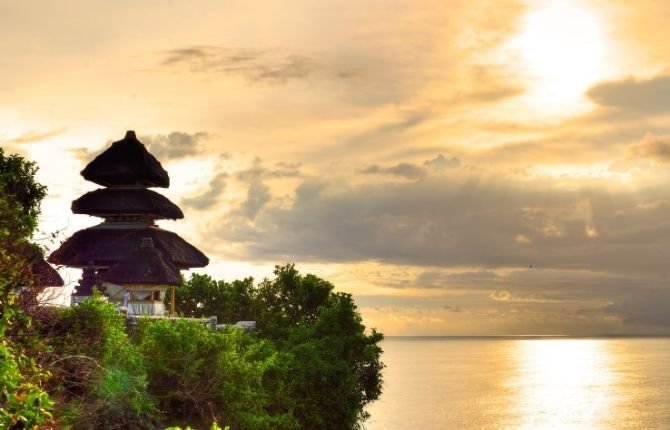Uluwatu Temple golden sunset view over the Indian Ocean Bali